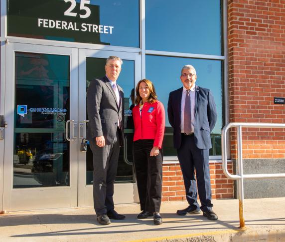 Dr. Pedraja, Karyn Polito, and Barry Maloney stand outside the front door of 25 Federal Street.