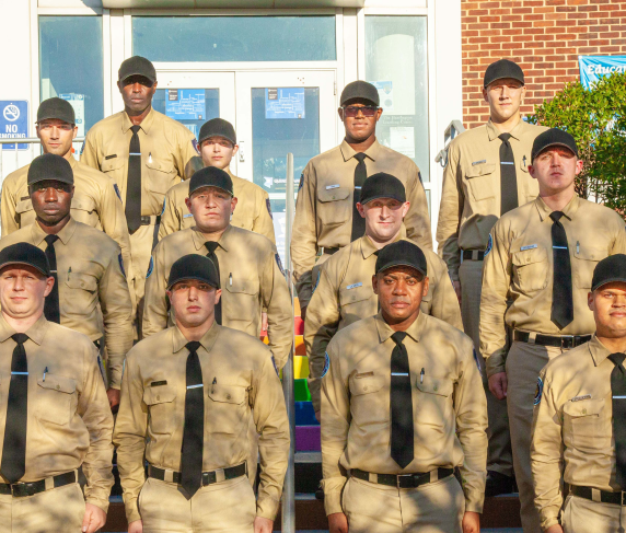 Academy recruits pose on the diversity steps in front of the Harrington Learning Center