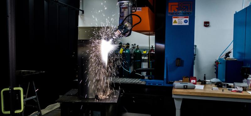 A laser cuts metal in a manufacturing lab