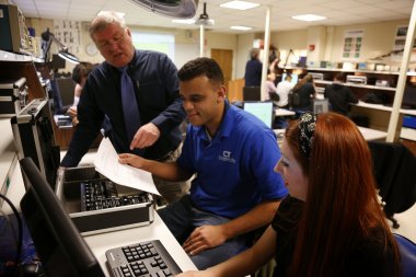 QCC instructor demonstrates computer hardware to students
