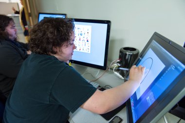 QCC student illustrates with computer screen tablet