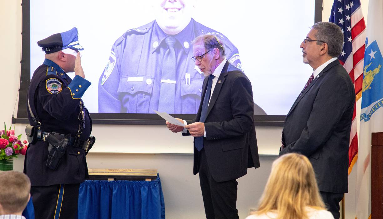 COO/CFO Stephen Marini (center) swears in Police Chief Stephen DiGiovanni (left) with QCC President Dr. Luis Pedraja
