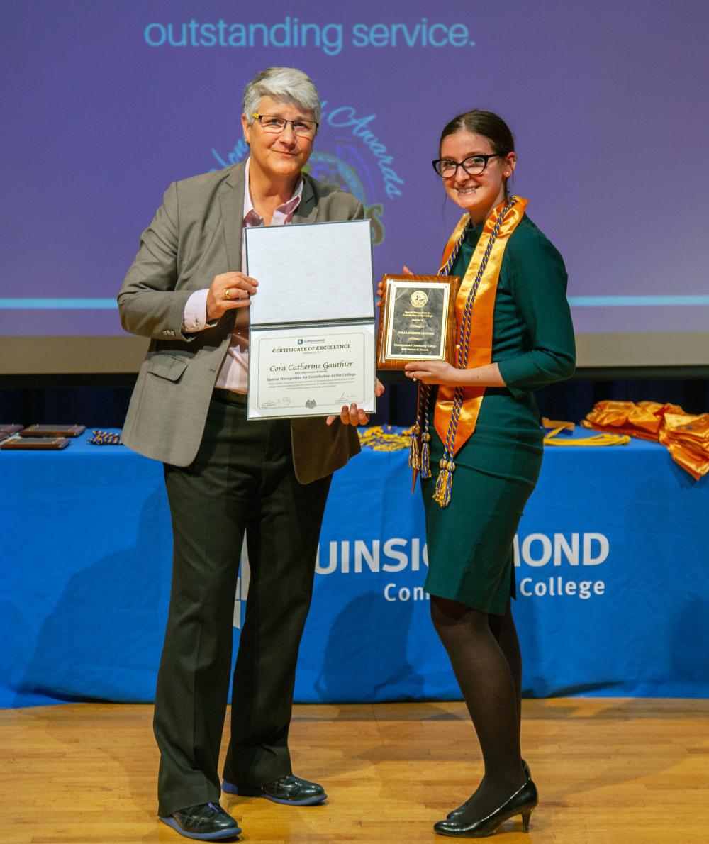 An honors student receives an award on stage during QCC’s annual Honors and Awards ceremony