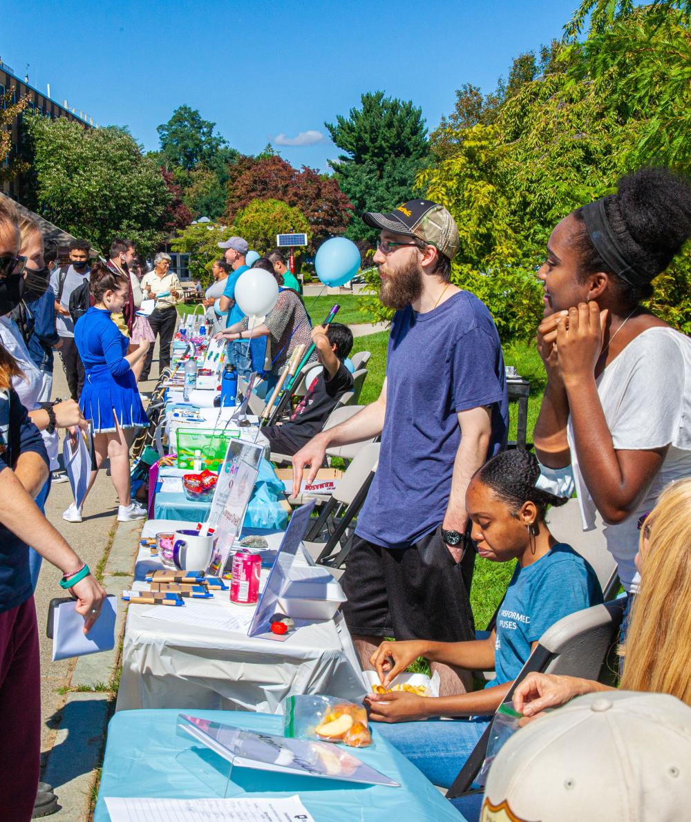 A crowd checks out various stands that are recruiting for QCC’s clubs on the campus Quad