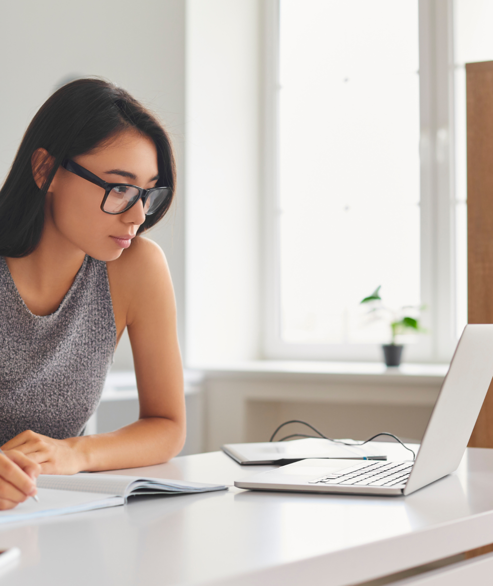 A female student registers from home using her laptop