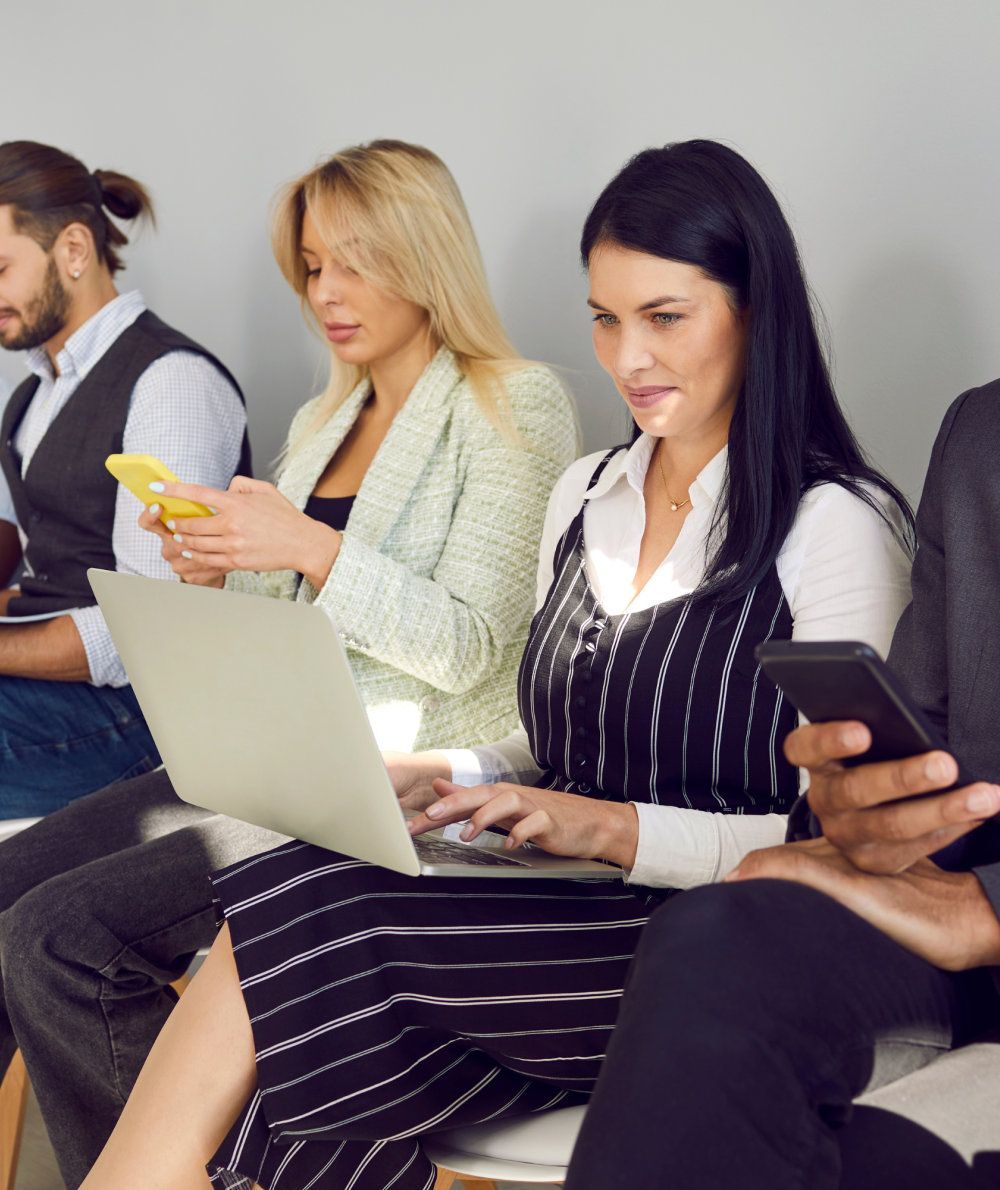 A line of sitting interviewees prepare for interviews