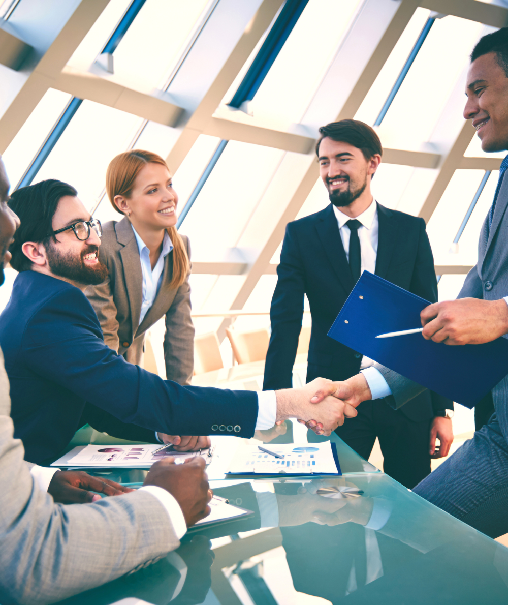 A bunch of business professionals chat in a workplace settings