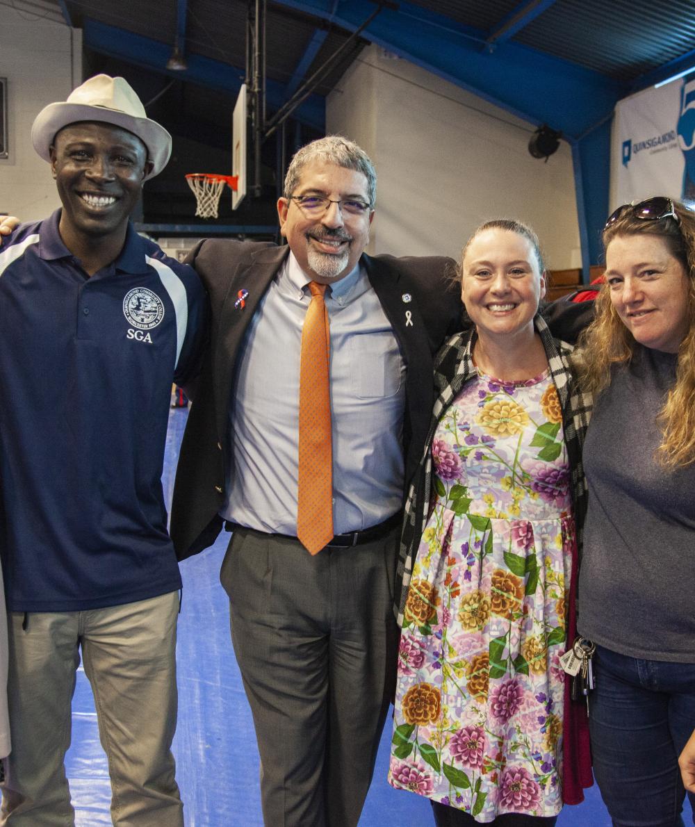 A group of staff, including the president, pose at Diversity Day