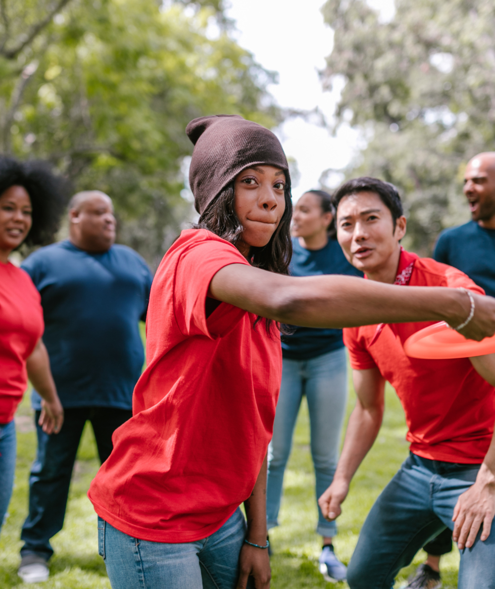 A group of students plays ultimate frisbee outside