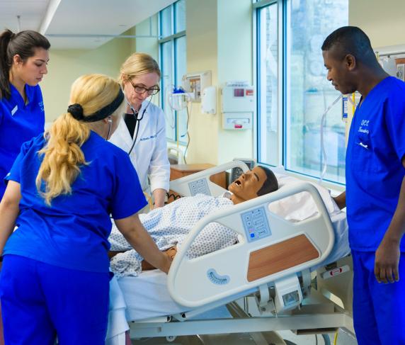 Nurses work on a dummy in a lab