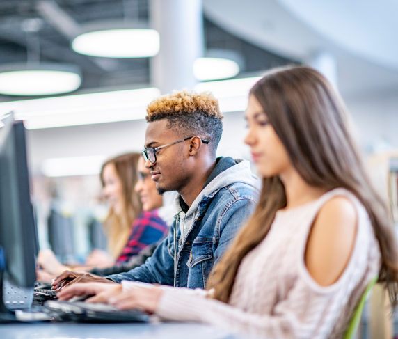 Students sit at desk and apply on the computer
