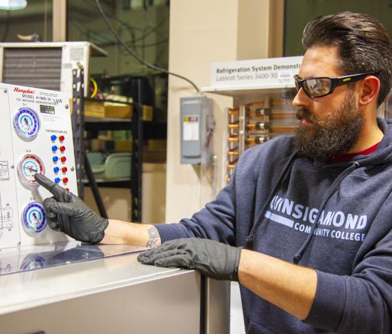 an HVAC student demonstrating how to use program-specific technology