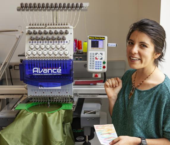 A student makes use of printing machinery in the fab lab