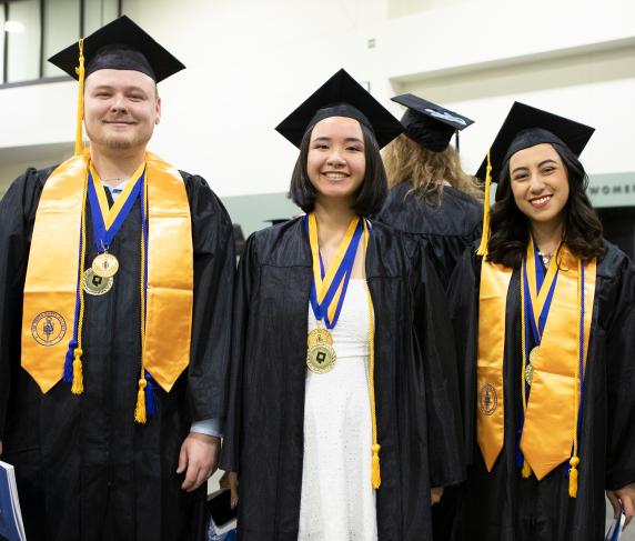 Psi Beta Graduates show off their regalia at QCC’s commencement at the DCu Center