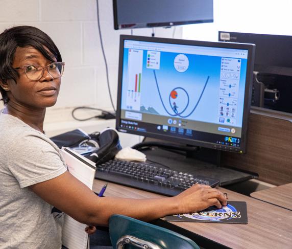 A woman works with diagnostic software on a computer in a STEM Workshop