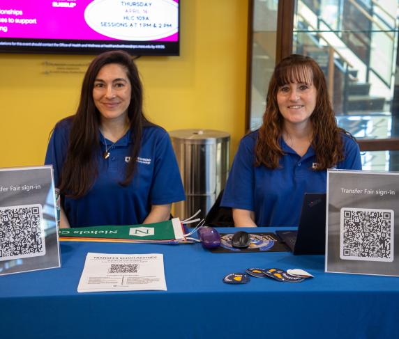 QCC transfer staff man a booth in the Harrington Learning Center