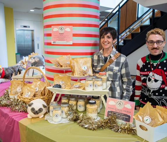 Marketing Manager Gina Cone (left) and student Tyler Wills with Cone's homemade dog treats