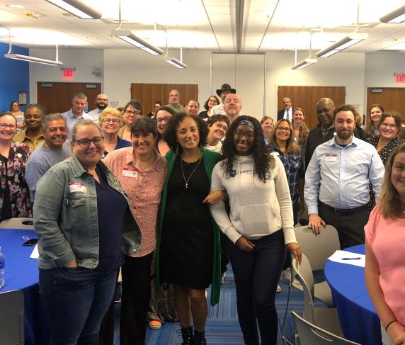 Maria Milagros (center in green) with QCC employees at the Staff Development Conference