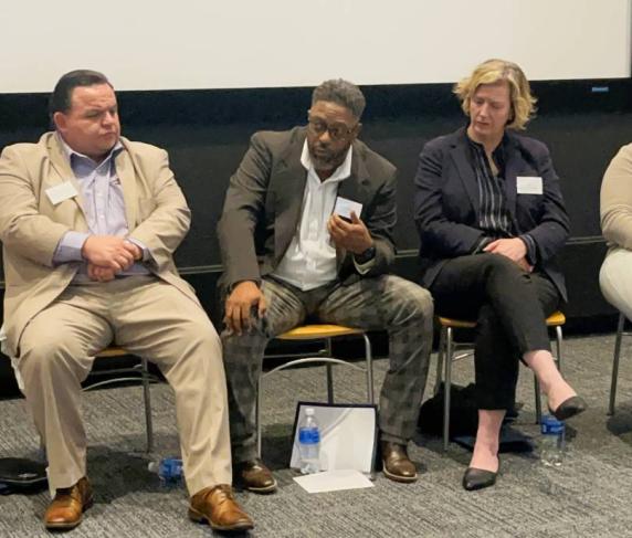 Director of Community Engagement Sean Harris (center) speaks at the Housing Justice Summit