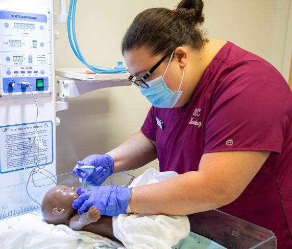 A QCC Nursing student using simulation equipment