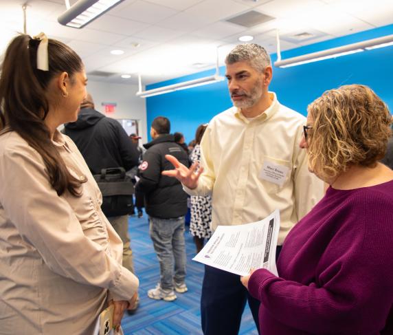 Marc Breau from the Executive Office of Health and Human Services speaks with job seekers.