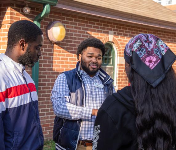 Director of Mentoring and Special Programs Kalan Lewis (center) at a mentoring event