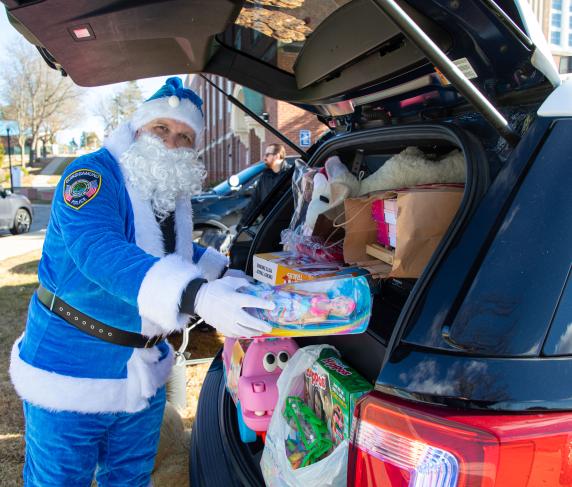 Blue Santa is at it again, preparing gifts for QCC families at Stuff A Cruiser.