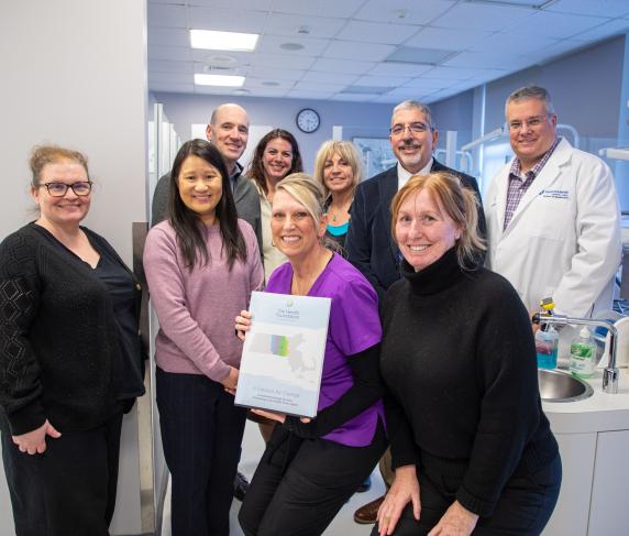 Front (from left) The Health Foundation Director of Finance and Administration Michelle L. Ewing, The Health Foundation President and CEO Amie Shei, Dental Clinic Operations & Facilities Mgr. Rene Cummings, and Prof. of Dental Assisting-Hygiene Jennifer McKeon. Back (from left) The Health Foundation Grants and Operations Manager Daniel P. Germain, Dir. of Grants Development Nicole Heldenbergh, Dental Hygiene Coordinator Jane Gauthier, QCC President Dr. Luis Pedraja, and Dean of Healthcare Pat Schmohl