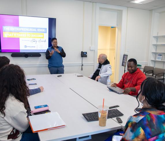Rocky Knight (standing), director of the Auxilium Center for Entrepreneurship, during a presentation at the Center.