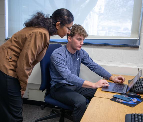 Professor Computer Information Systems Gargi Chug helps a student.