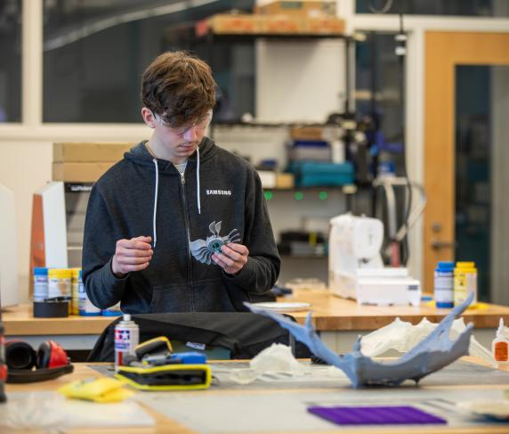 A student builds a 3D model in the fab lab