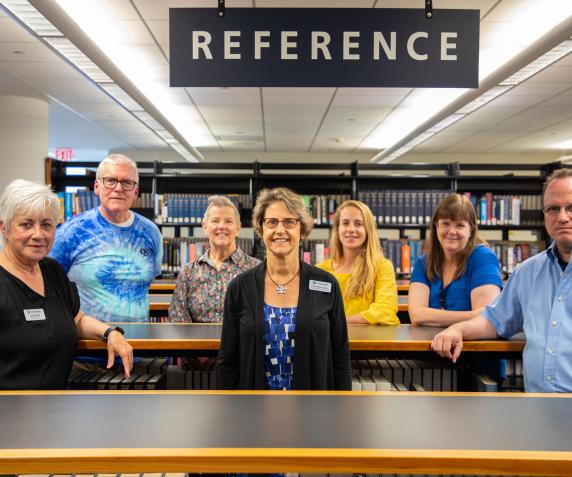 QCC’s library staff gather at the reference desk