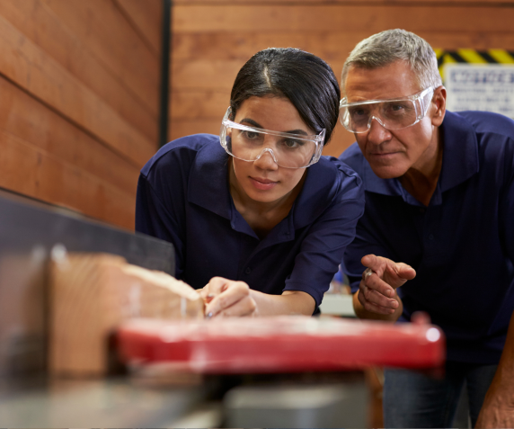 A student wears safety goggles in an apprenticeship enviroment