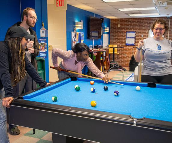 Students playing pool in the student center