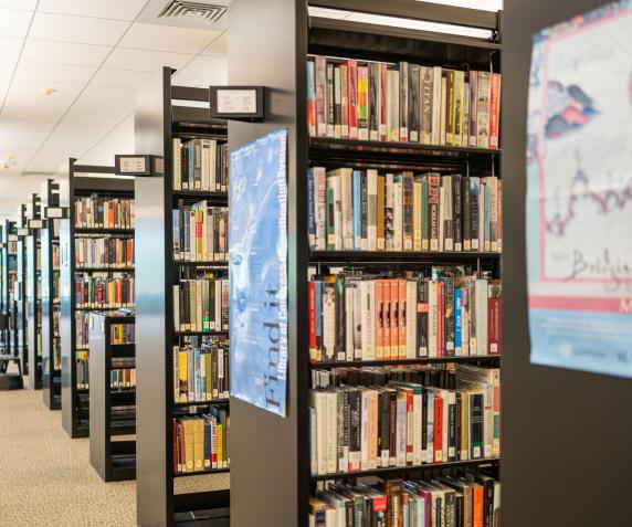 Several shelves in the Alden Library filled with books