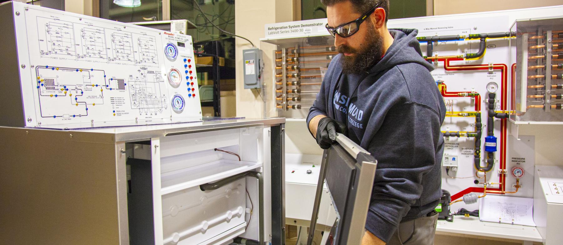 A man takes apart an appliance