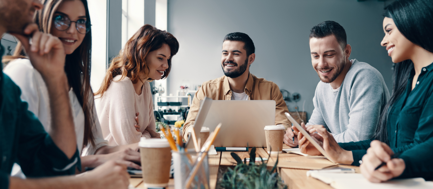 A group of business professionals sit at a table and chat