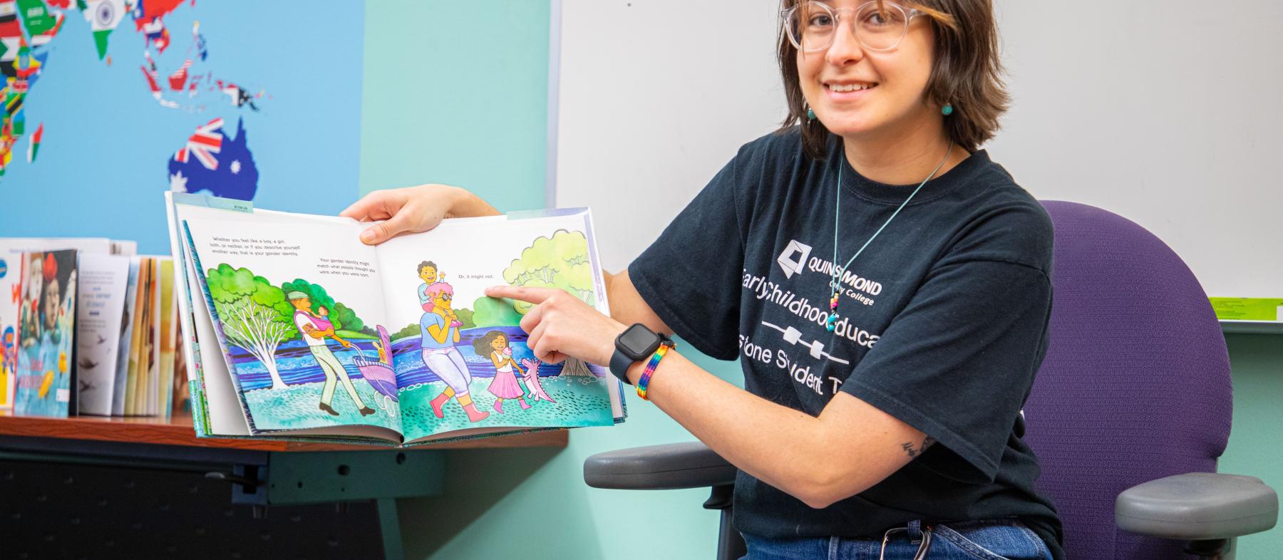 An ECE student reads a book to the class