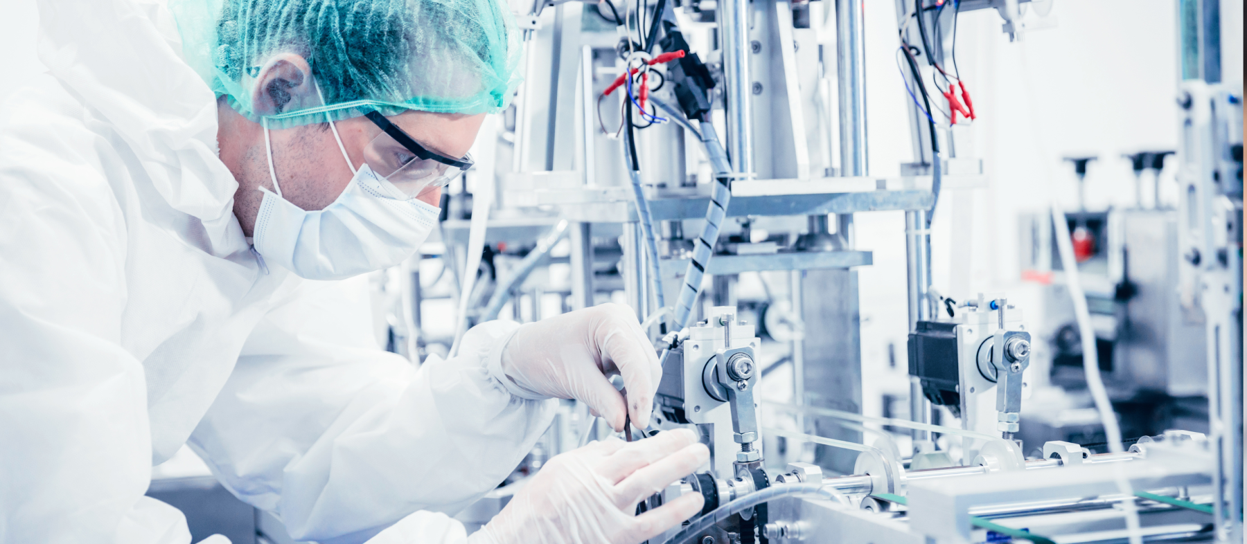 A man configures medical machinery in a lab