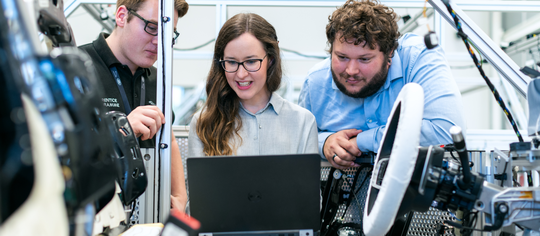 A class of students works with a computer in an engineering lab