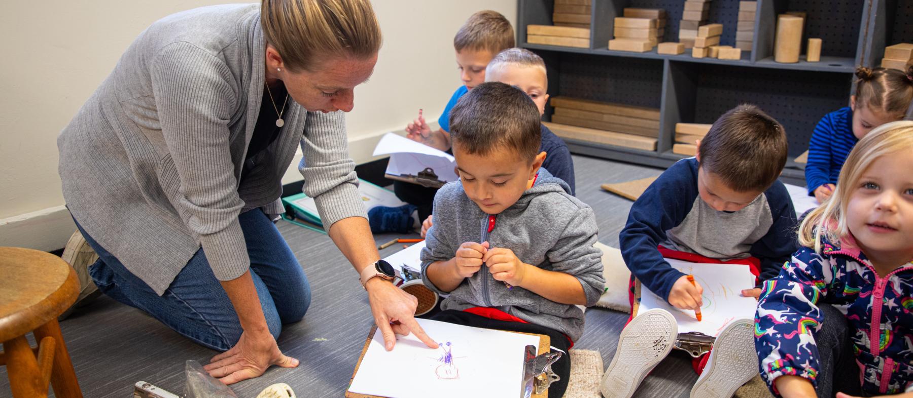 A teacher works with a class of young children