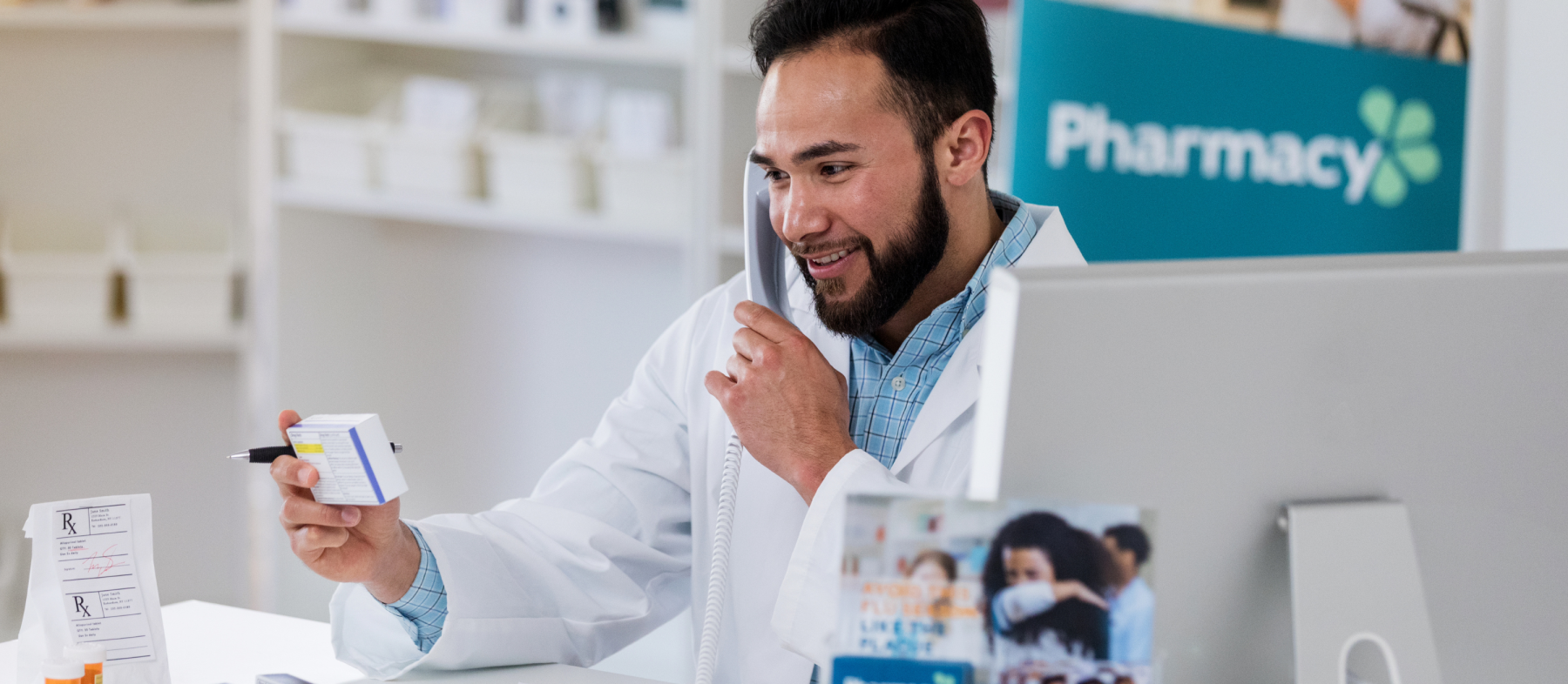 A man in a lab coat works in a pharmacy