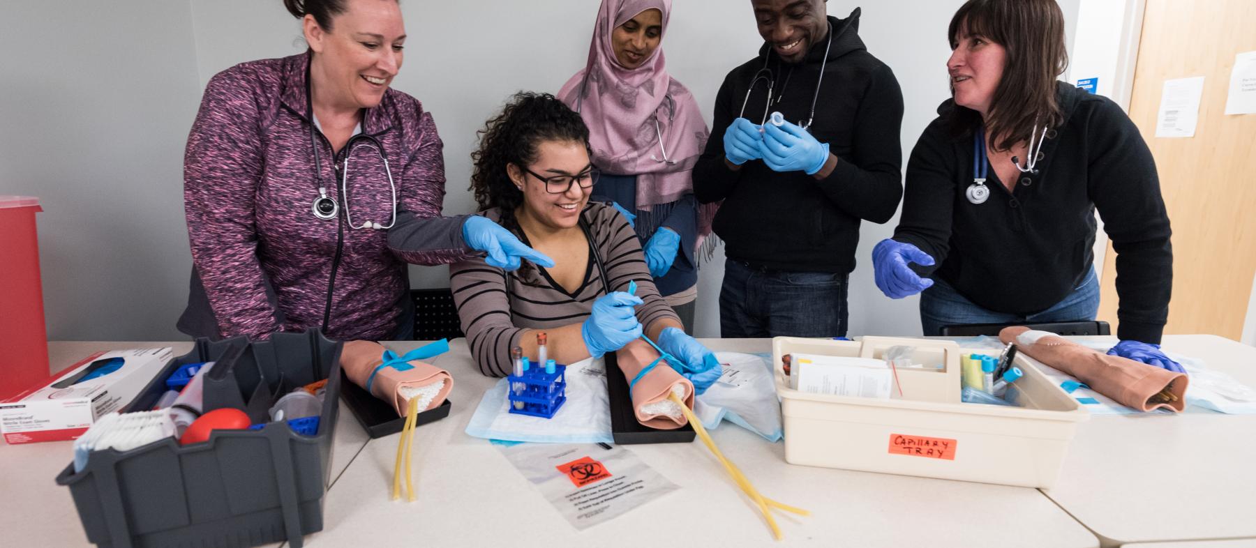 Students examine medical instruments in class