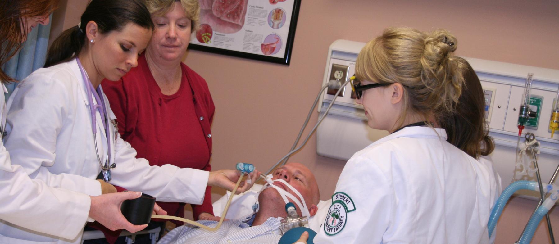 Students work on a volunteer in a lab