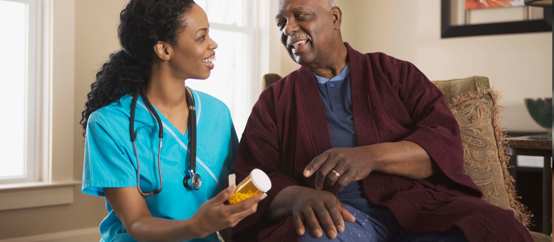 A nurse assists a patient in his home