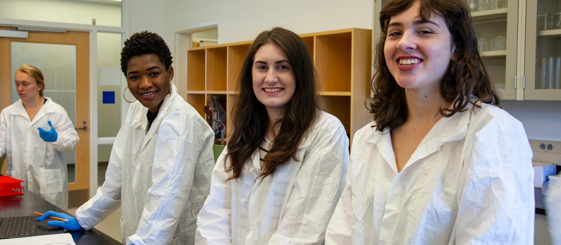 Pharmacy Tech students work at a desk in a lab