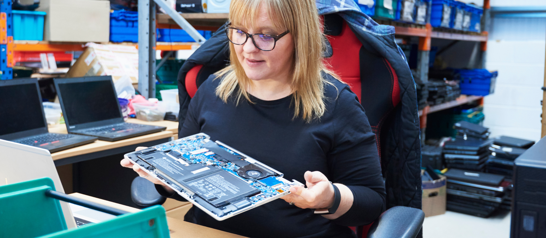 A woman holds a circuitboard