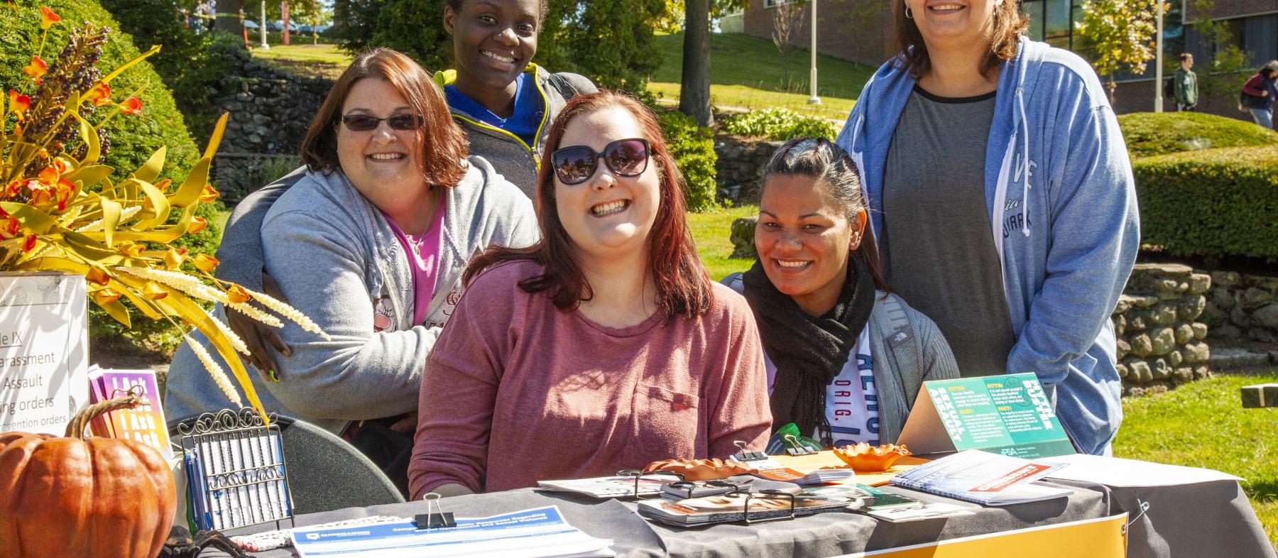 Various students recruit for the Student Peer club on the campus quad during the autumn Club Fair