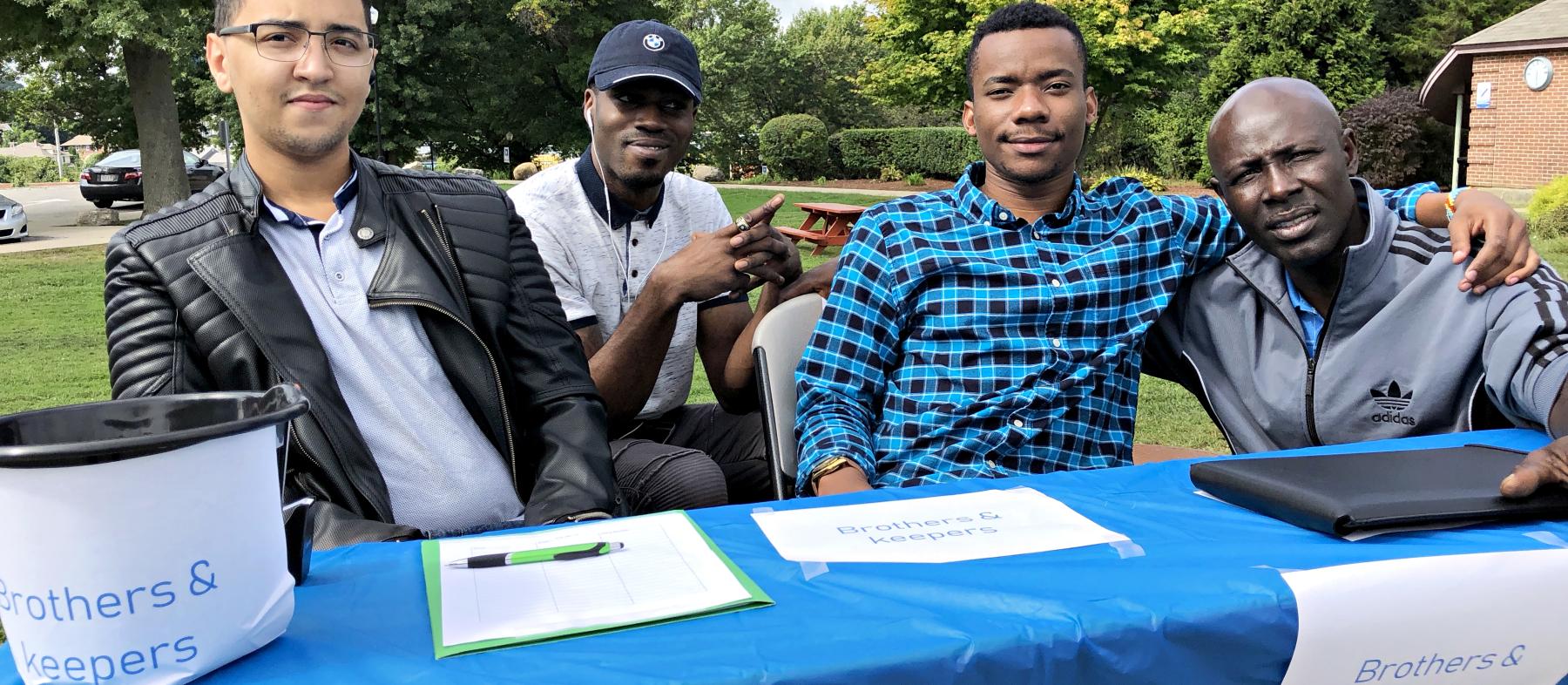 Students at the Brothers & Keepers booth at a club fair