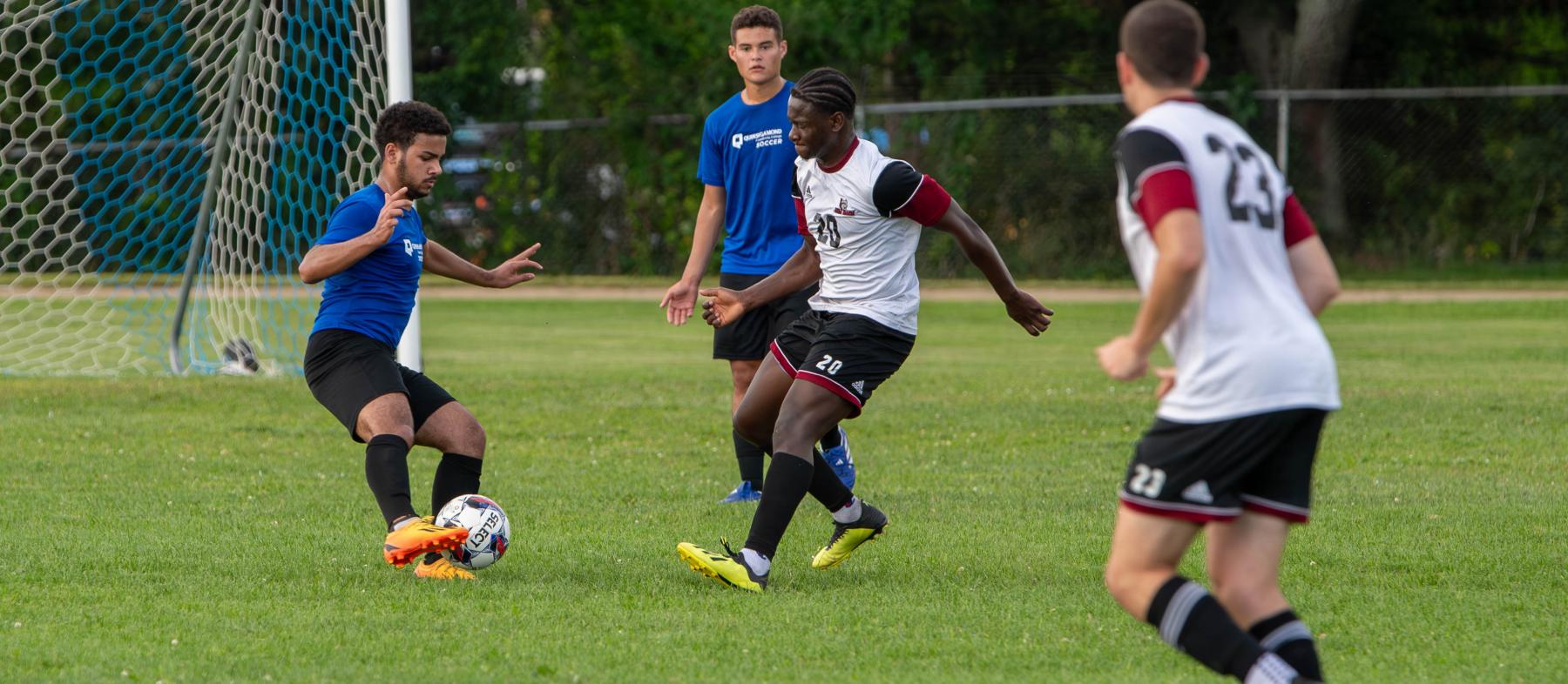 QCC soccer players on the field